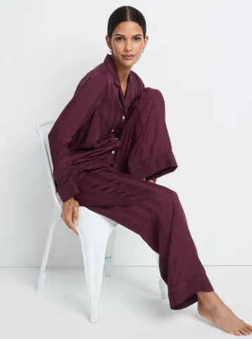 Woman wearing a maroon set of pajamas.