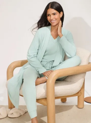 Woman wearing a mint green pajama set. 
