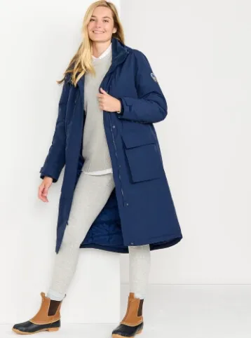 Woman wearing a Squall stadium maxi coat and duck boots.