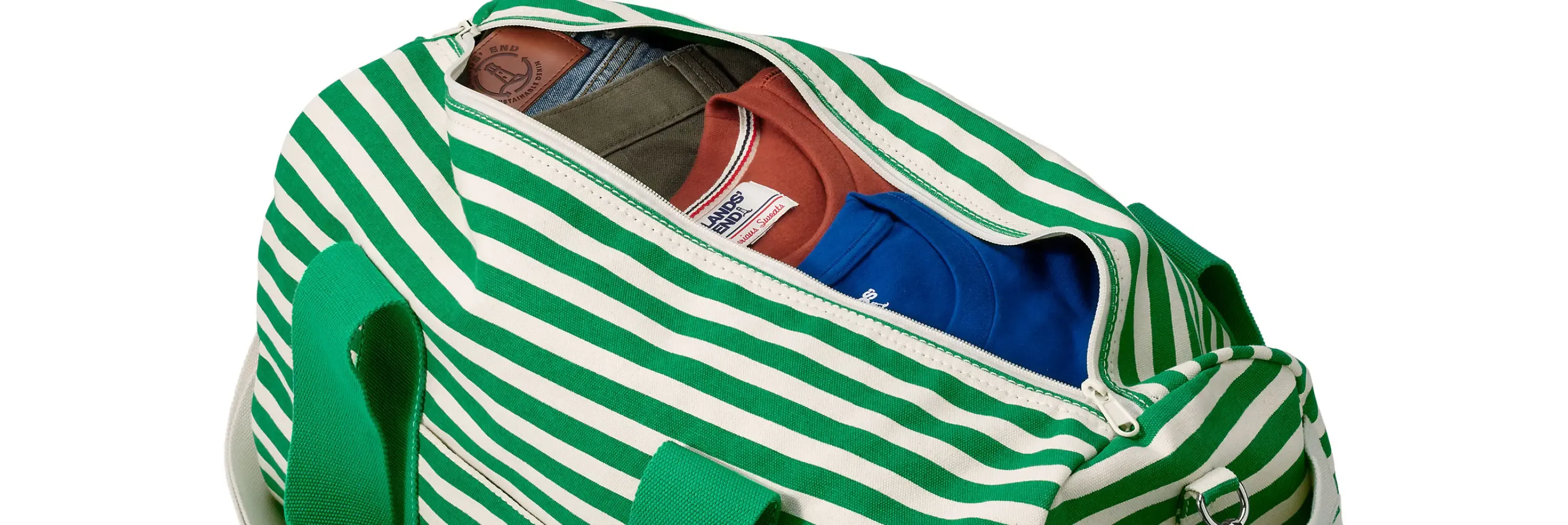 Green striped canvas weekender bag showing organized packed clothing inside.