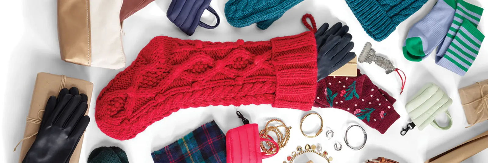 Festive holiday accessories including a red knit scarf, gloves, and jewelry.