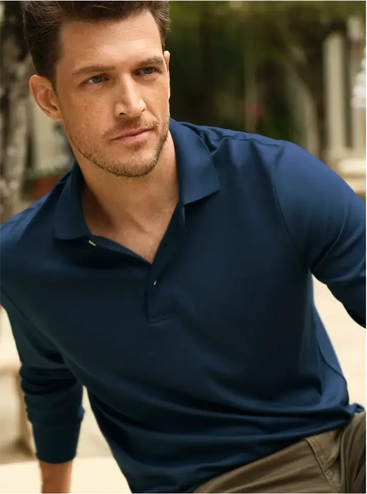 Man wearing a long sleeve navy polo shirt