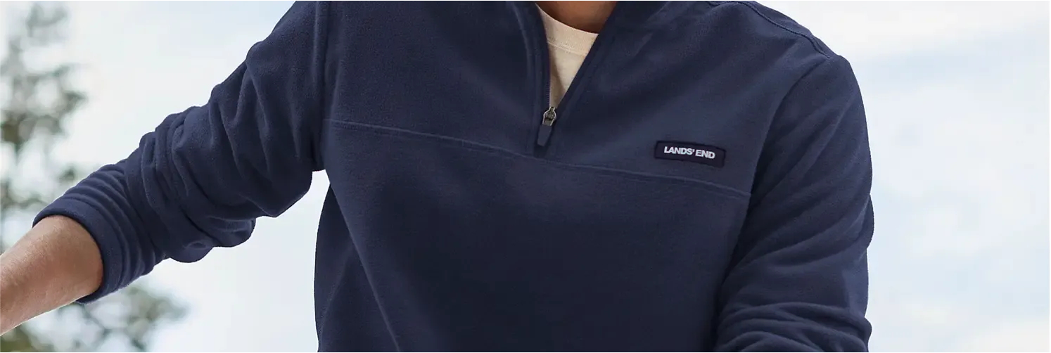 Man wearing a navy blue quarter-zip AnyWeather fleece pullover.