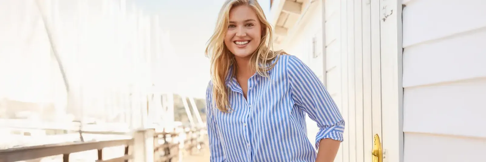 Woman in a white and blue striped button-down shirt.