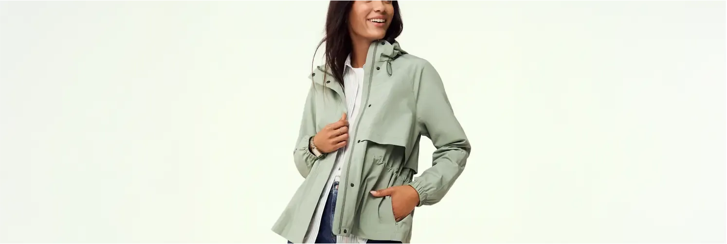 Woman wearing a light green hooded jacket.