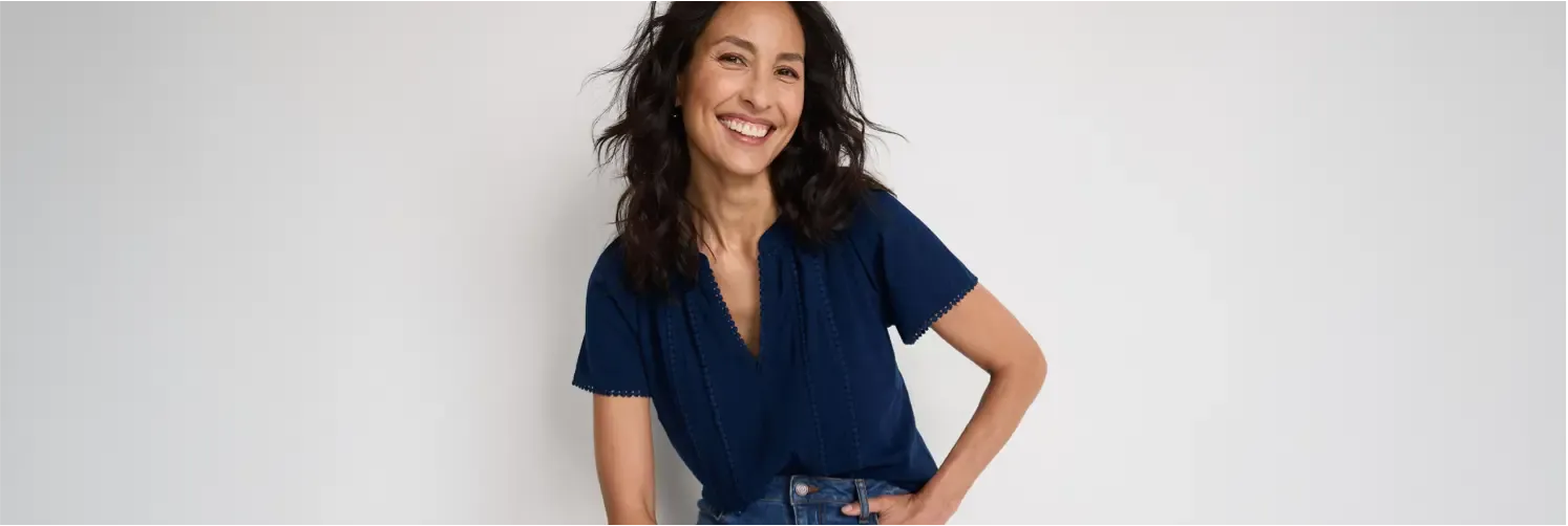 Woman wearing a navy T-shirt and dark jeans