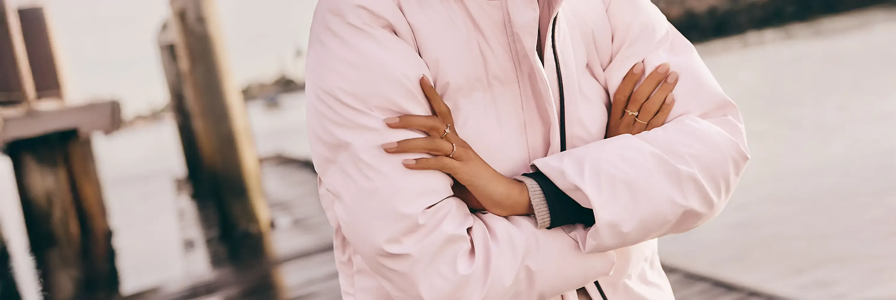 Woman wearing a pink bomber jacket.