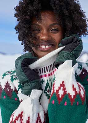 Woman wearing a sweater and gloves