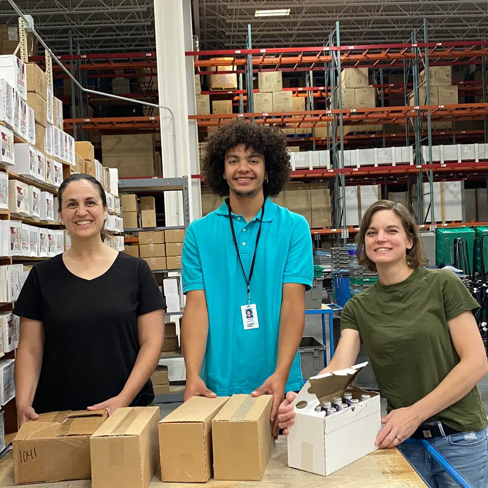 Three employees working in one of Lands&rsquo; End&rsquo;s warehouses.